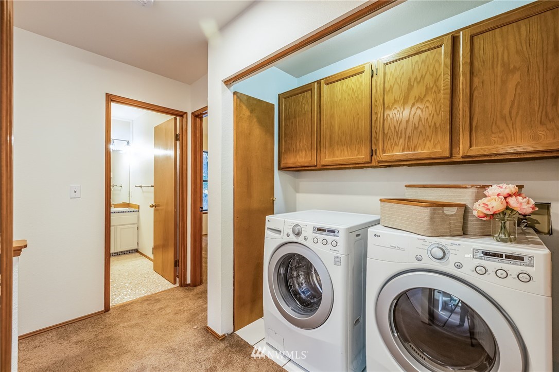 23511 Meridian Avenue South Bothell, WA 98021 - Photo 34 of 40 a view of a storage & utility room with washer and dryer