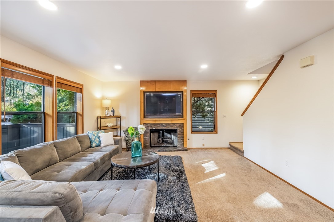 23511 Meridian Avenue South Bothell, WA 98021 - Photo 8 of 40 a living room with furniture a fireplace and a floor to ceiling window