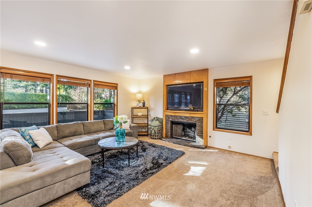 23511 Meridian Avenue South Bothell, WA 98021 - Photo 9 of 40 a living room with furniture large window and a fireplace