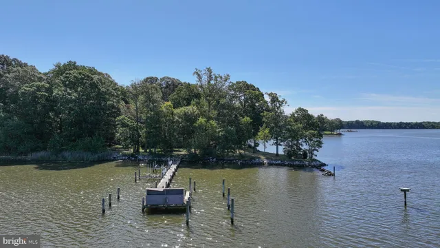 a kitchen with stainless steel appliances kitchen island granite countertop lots of white cabinets a sink and dishwasher