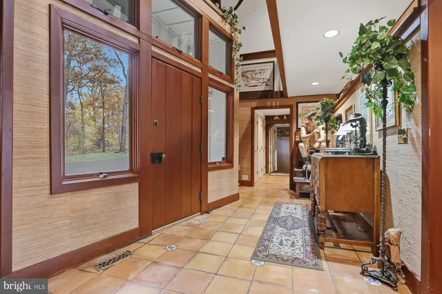 a living room with furniture a rug and a fireplace