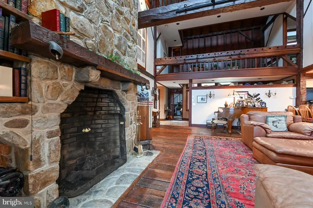 a large living room with stainless steel appliances kitchen island granite countertop a large window and a counter top space