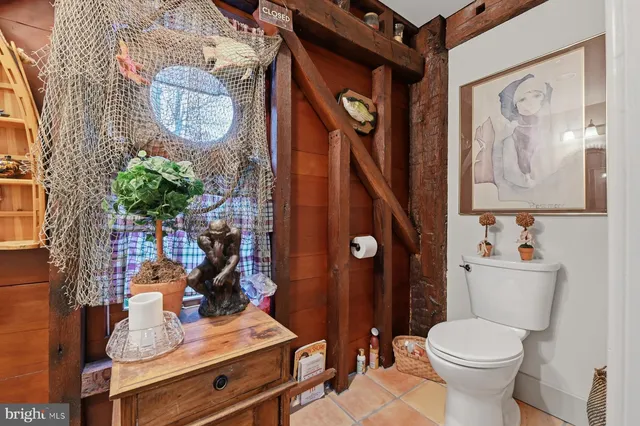 a bathroom with a toilet a sink and a mirror