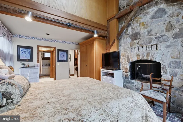 a bed sitting in a bedroom next to a window