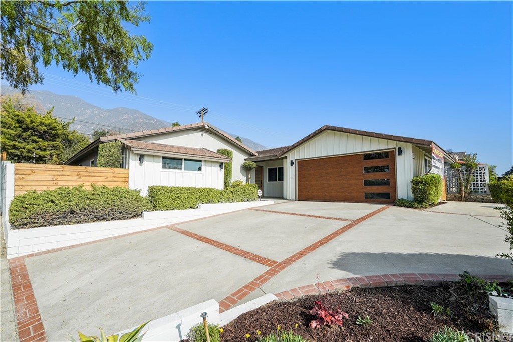 3675 Denair Street Pasadena, CA 91107 - Photo 2 of 37 a front view of a house with a yard and garage