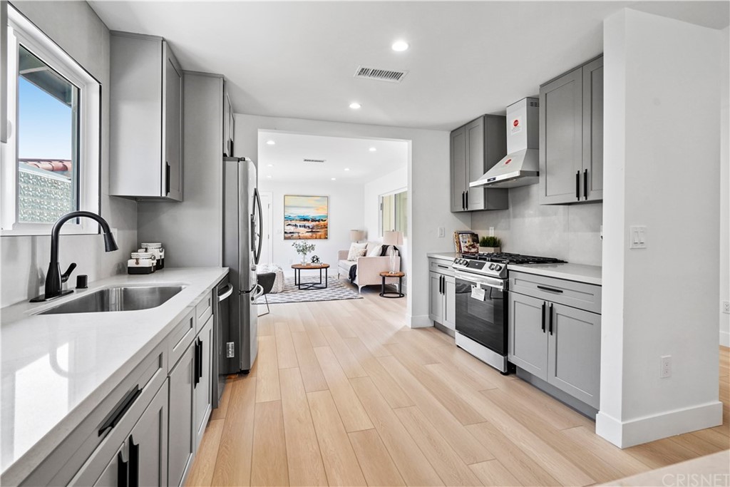 3675 Denair Street Pasadena, CA 91107 - Photo 11 of 37 a kitchen with stainless steel appliances granite countertop a sink stove and refrigerator