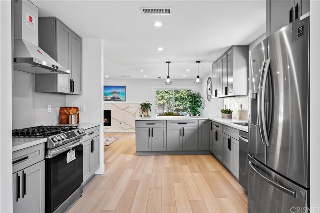 3675 Denair Street Pasadena, CA 91107 - Photo 15 of 37 a kitchen with stainless steel appliances a refrigerator sink and stove