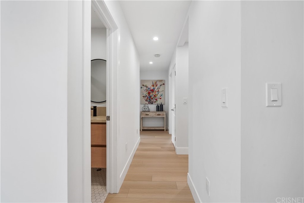 3675 Denair Street Pasadena, CA 91107 - Photo 17 of 37 a view of a hallway with wooden shelves