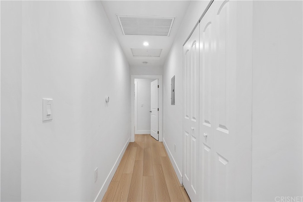 3675 Denair Street Pasadena, CA 91107 - Photo 19 of 37 a view of a hallway with wooden floor and a bathroom