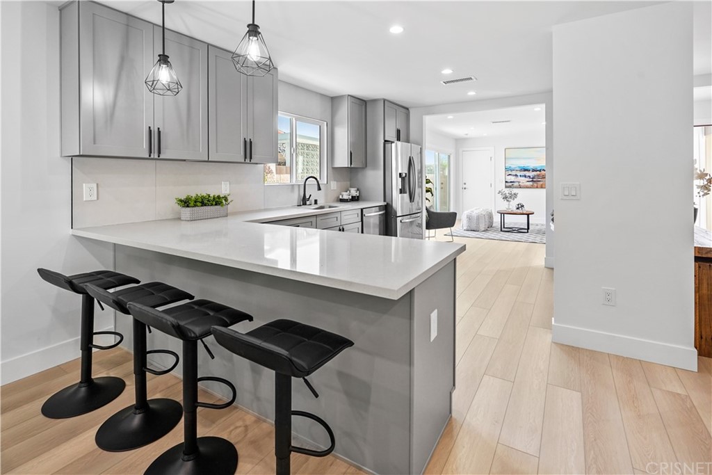 3675 Denair Street Pasadena, CA 91107 - Photo 9 of 37 a kitchen with a sink cabinets and wooden floor