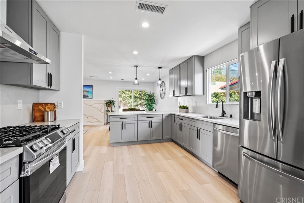 3675 Denair Street Pasadena, CA 91107 - Photo 10 of 37 a kitchen with stainless steel appliances a refrigerator sink and stove