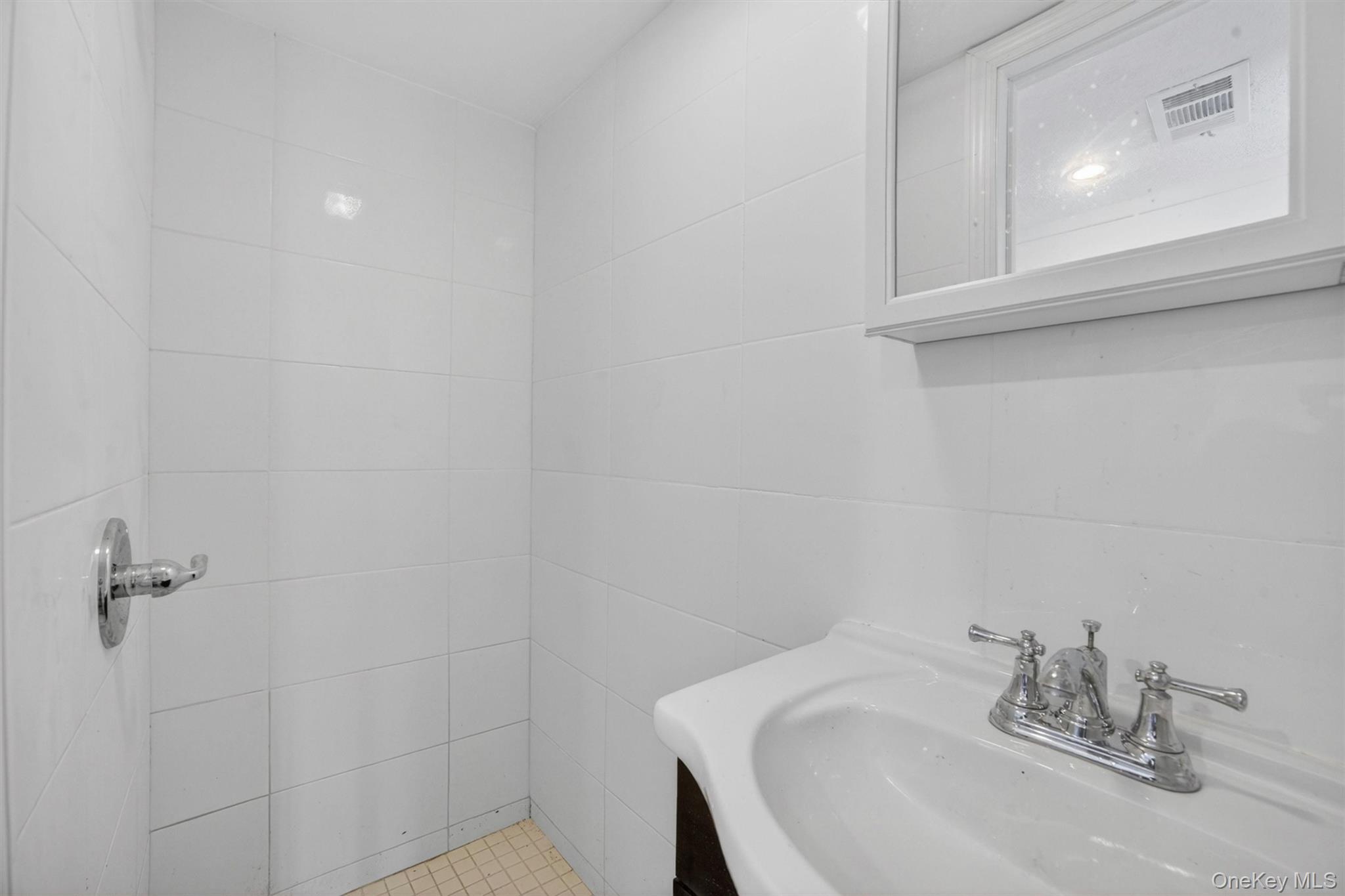 263 Croydon Road Yonkers, NY 10710 - Photo 31 of 43 a bathroom with a sink and cabinets