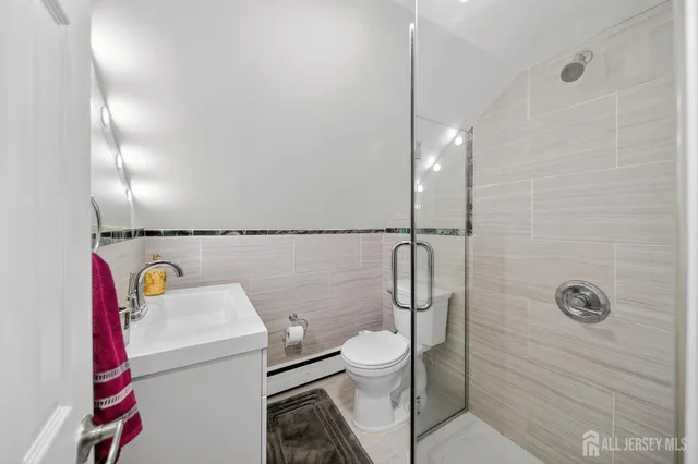 a bedroom with a bed and a night stand