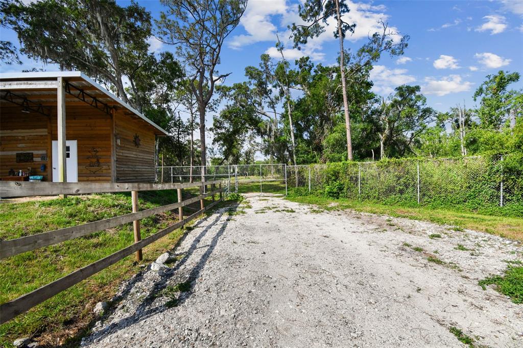 2853 Saffold Road Wimauma, FL 33598 - Photo 7 of 62 a view of a backyard with wooden fence