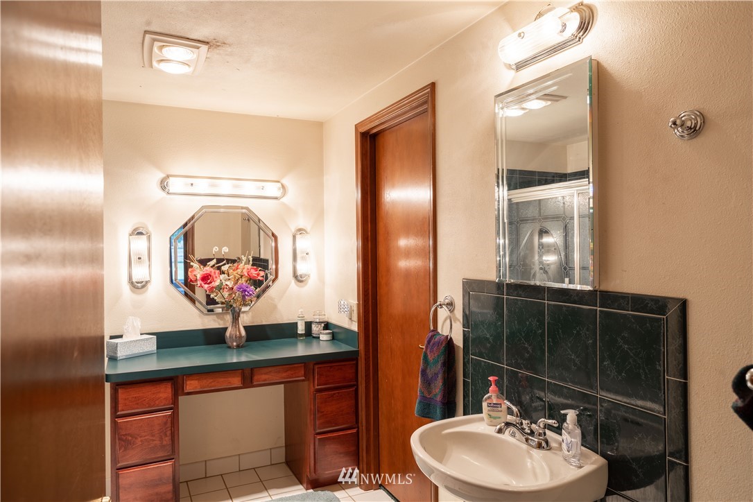 18703 Joselyn Road Southwest Rochester, WA 98579 - Photo 13 of 40 a bathroom with a sink mirror and vanity