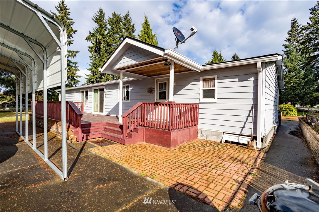 18703 Joselyn Road Southwest Rochester, WA 98579 - Photo 16 of 40 a view of a house with wooden deck furniture and floor to ceiling window