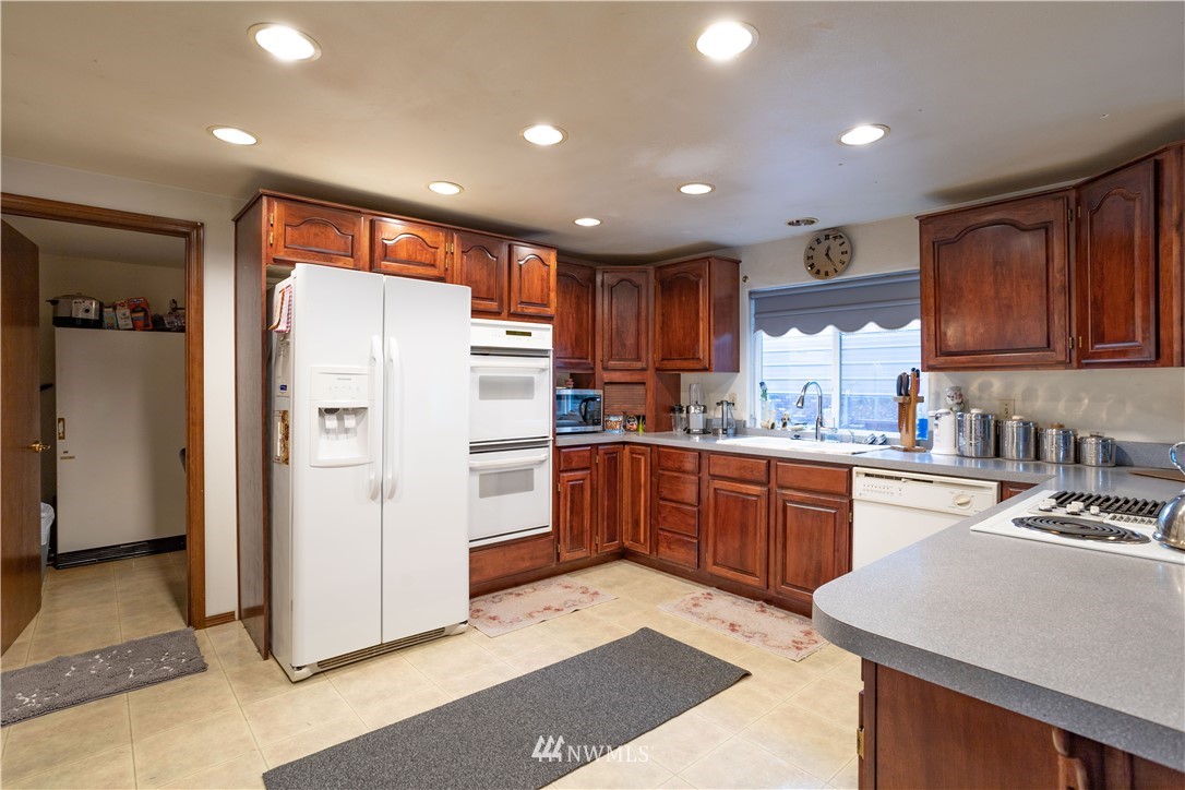 18703 Joselyn Road Southwest Rochester, WA 98579 - Photo 4 of 40 a kitchen with refrigerator cabinets and wooden floor