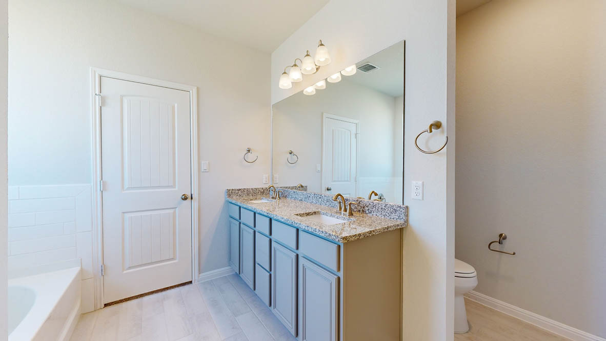 808 Gauge Road Thorndale, TX 76577 - Photo 14 of 31 A refined bathroom featuring a double vanity with granite counters and light-toned flooring.