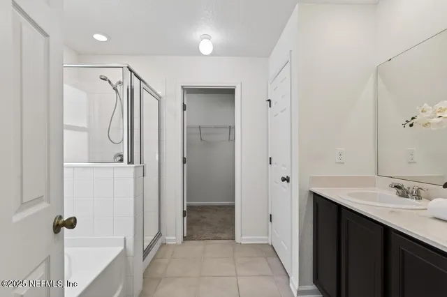 a bathroom with a double vanity sink mirror and shower