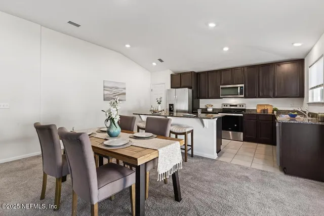 a kitchen with a table and chairs in it