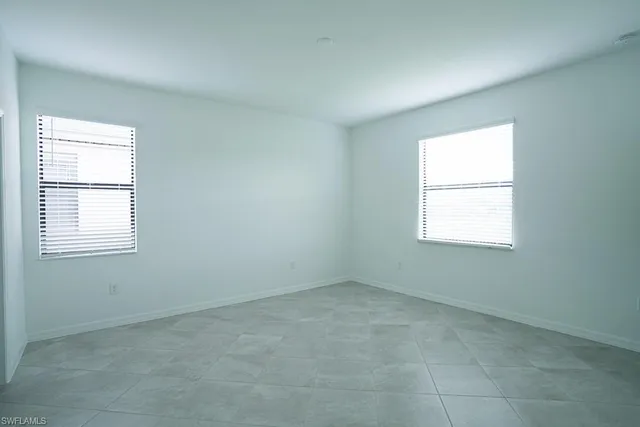 a spacious bathroom with a granite countertop sink two mirror and shower