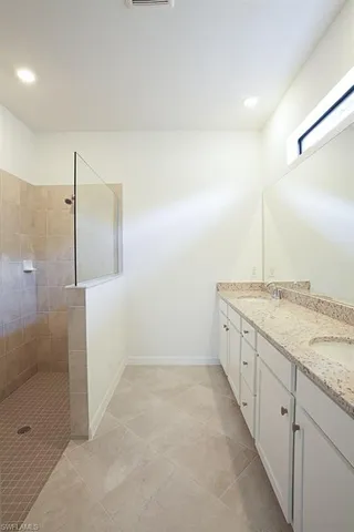 a large kitchen with cabinets and stainless steel appliances