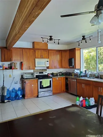 a kitchen with stainless steel appliances wooden cabinets counter space and a sink