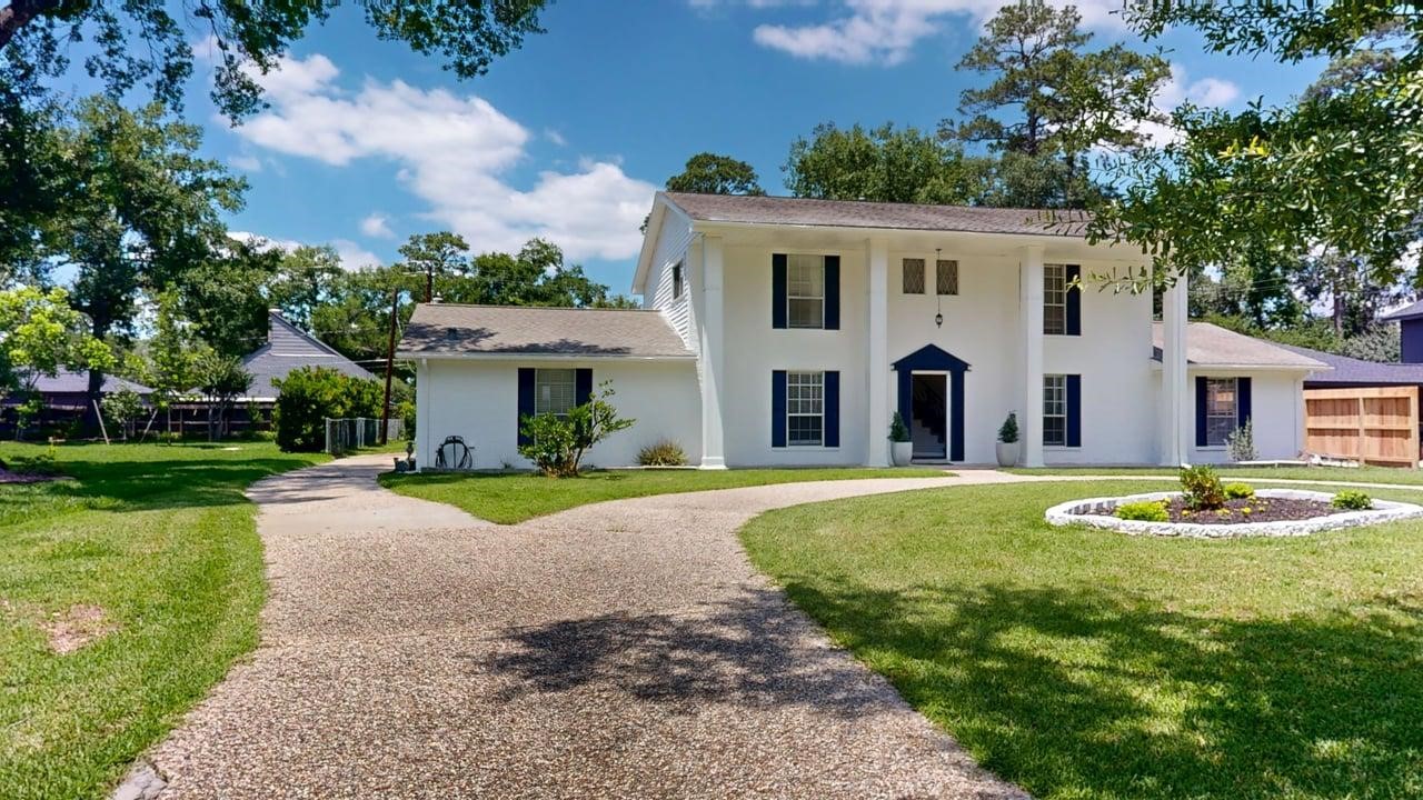 619 Cotter Drive Spring, TX 77373 - Photo 2 of 50 a view of a white house with a yard potted plants and a large tree