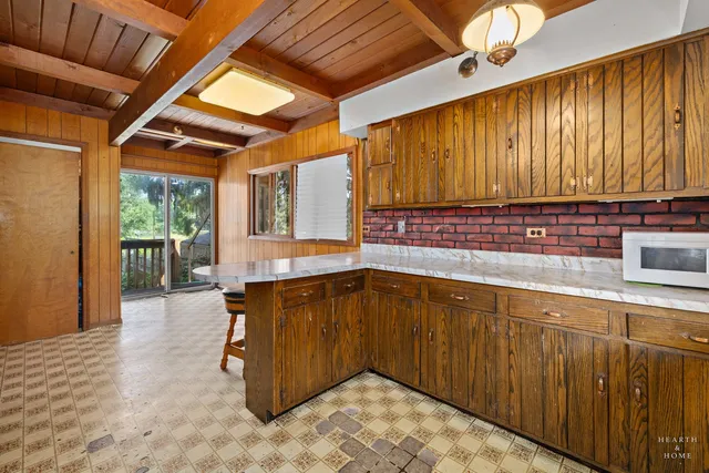 a kitchen with refrigerator and window