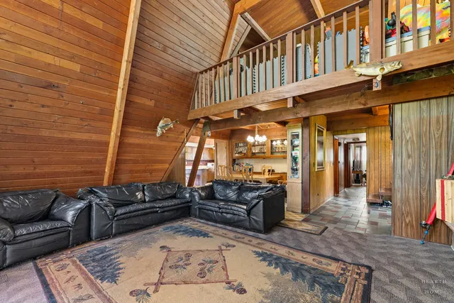a view of a dining room with furniture a chandelier and wooden floor