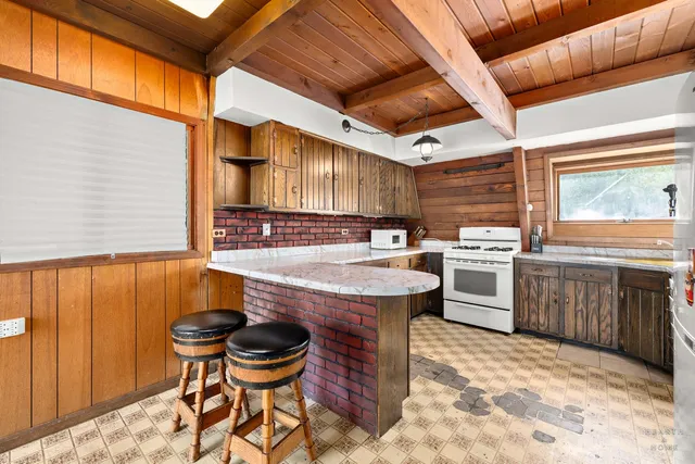 a kitchen with a stove sink and cabinets
