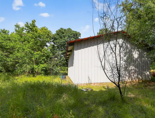 a view of a lush green forest with lots of trees