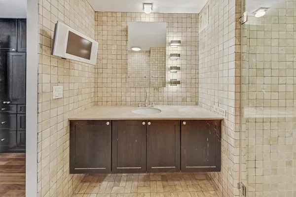 a bathroom with a shower and a sink