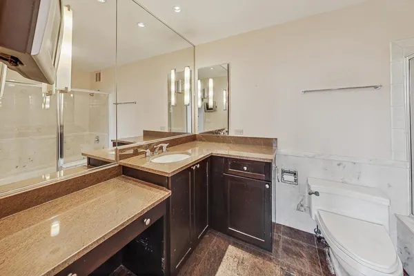 a bathroom with a shower a toilet and sink