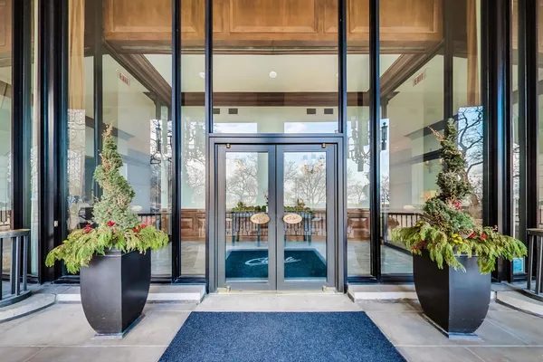 a view of a entryway of the house with flower pots
