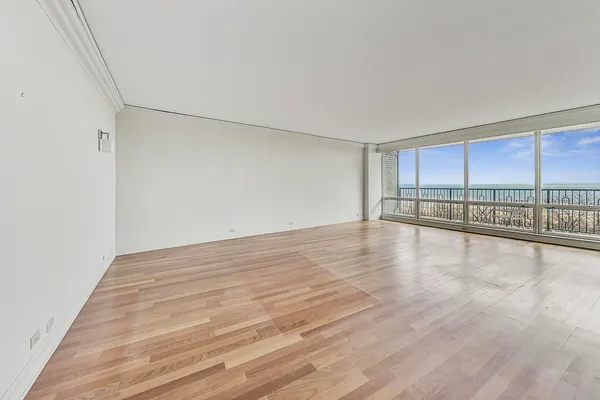 a view of a room with wooden floor