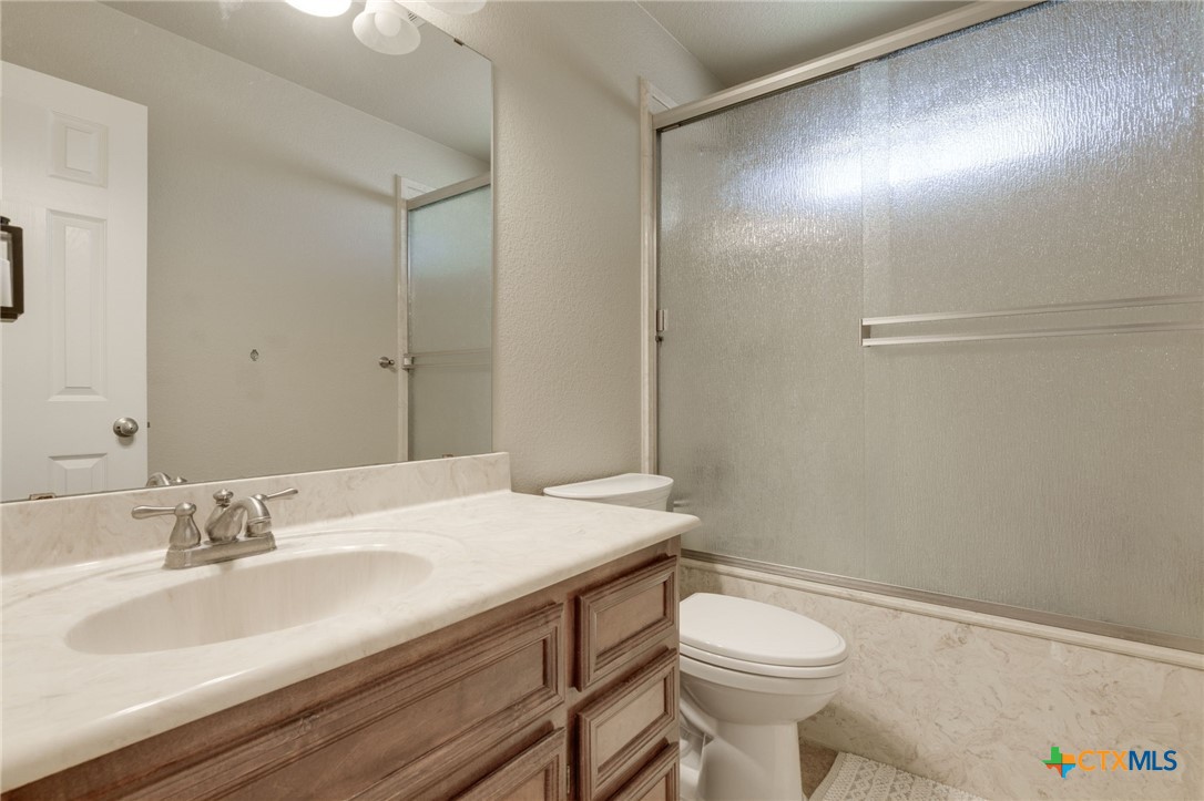 1467 County Road 4820 Kempner, TX 76539 - Photo 15 of 38 a bathroom with a sink toilet and vanity