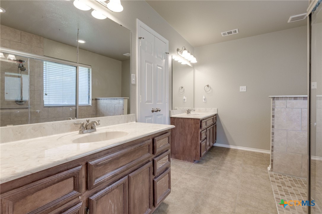 1467 County Road 4820 Kempner, TX 76539 - Photo 22 of 38 a spacious bathroom with a granite countertop sink mirror and a