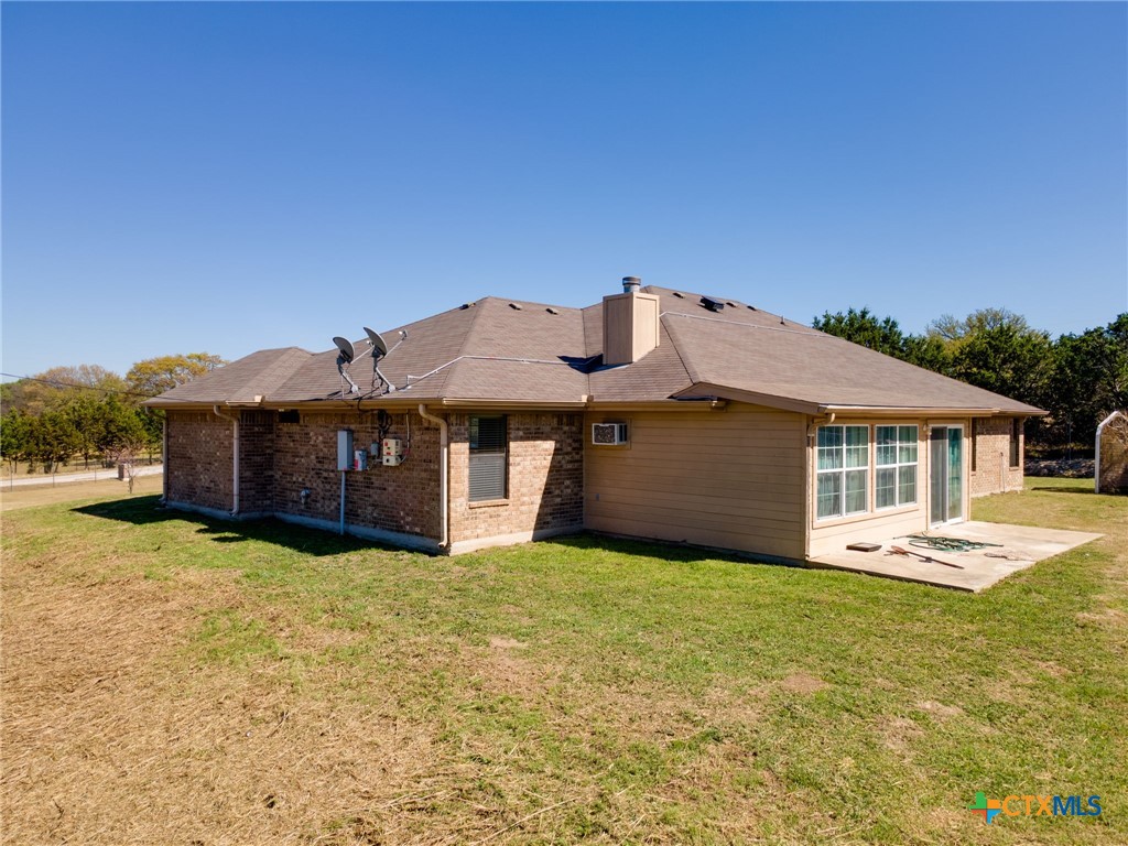 1467 County Road 4820 Kempner, TX 76539 - Photo 26 of 38 a view of a house with table and chairs under an umbrella