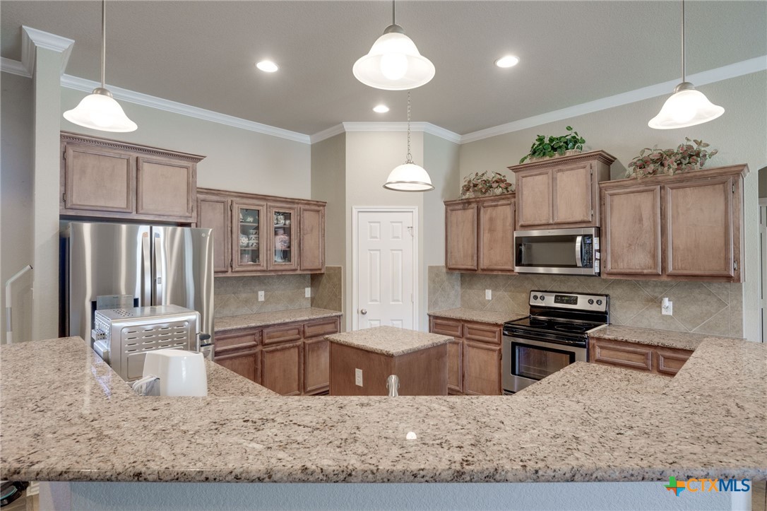 1467 County Road 4820 Kempner, TX 76539 - Photo 9 of 38 a kitchen with kitchen island granite countertop a sink stainless steel appliances and cabinets