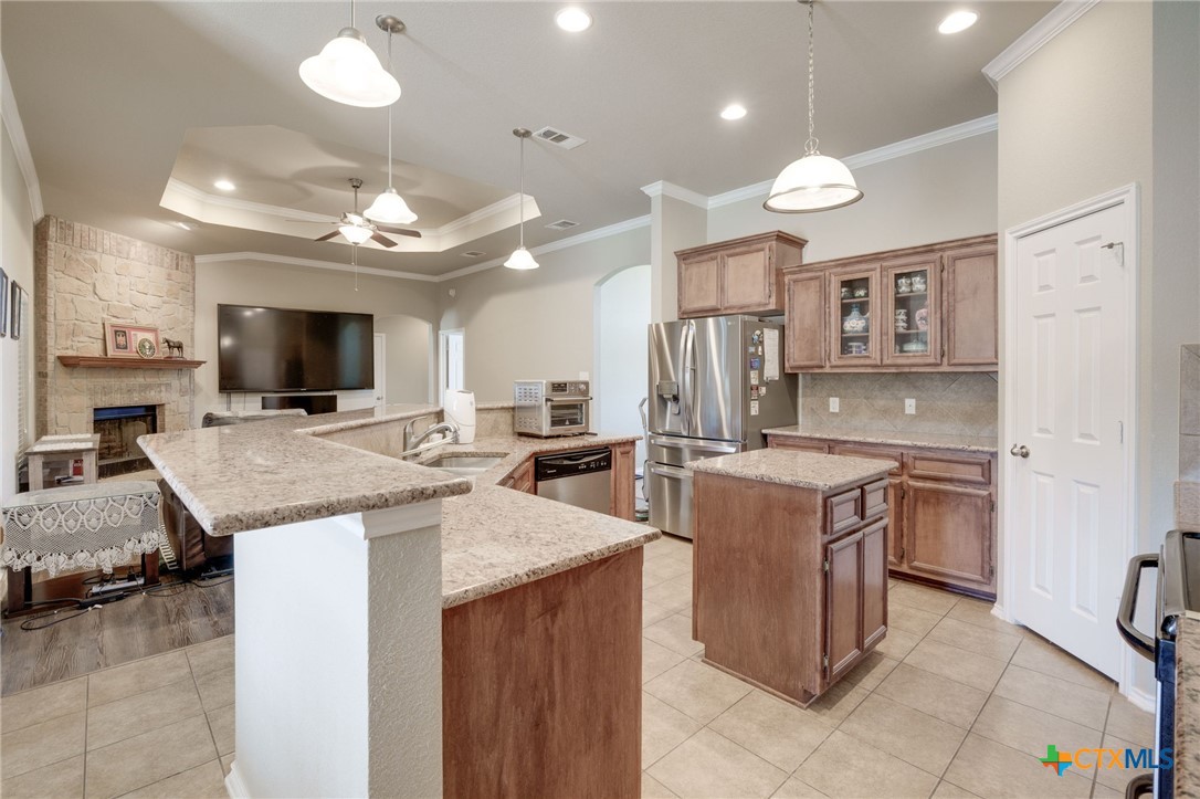 1467 County Road 4820 Kempner, TX 76539 - Photo 10 of 38 a kitchen with stainless steel appliances a stove top oven a sink dishwasher a dining table and chairs