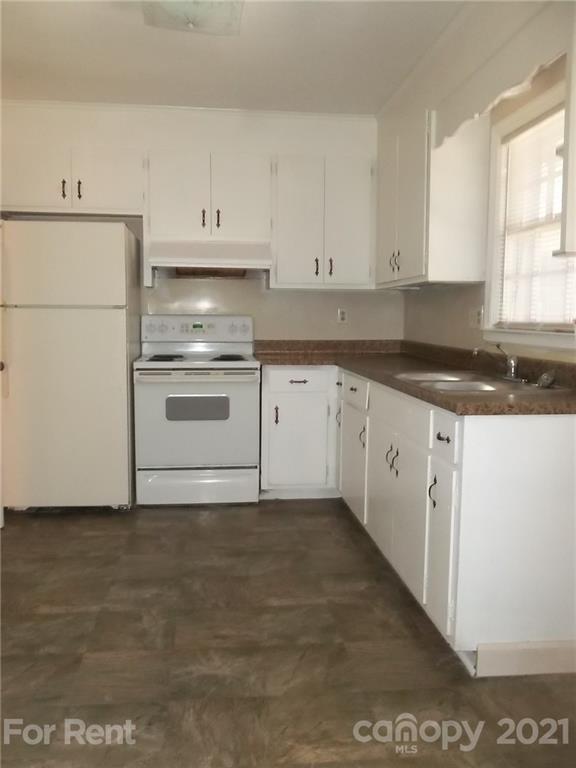 4227 Walker Road, Unit 6 Charlotte, NC 28211 - Photo 2 of 7 a kitchen with granite countertop white cabinets and white appliances