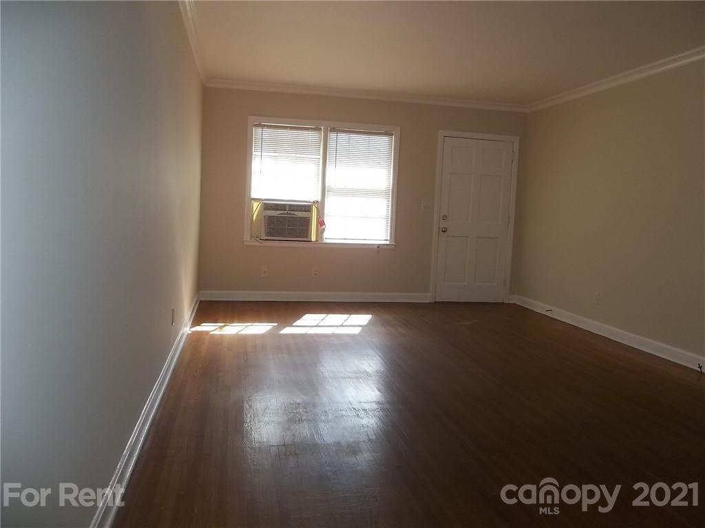 4227 Walker Road, Unit 6 Charlotte, NC 28211 - Photo 3 of 7 an empty room with wooden floor and windows