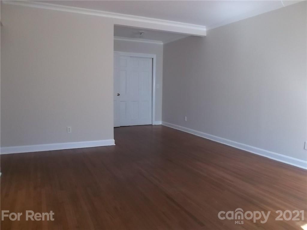 4227 Walker Road, Unit 6 Charlotte, NC 28211 - Photo 4 of 7 a view of an empty room with wooden floor