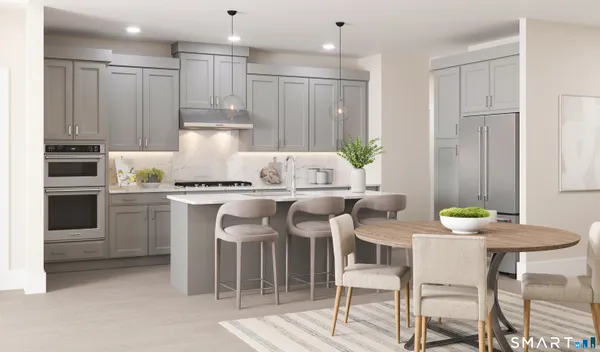 a kitchen with kitchen island granite countertop a table and chairs in it