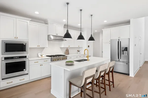 a kitchen with a stove a sink and a refrigerator