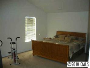 2213 Gooseberry Road Charlotte, NC 28208 - Photo 5 of 8 a bed sitting in a room next to a window