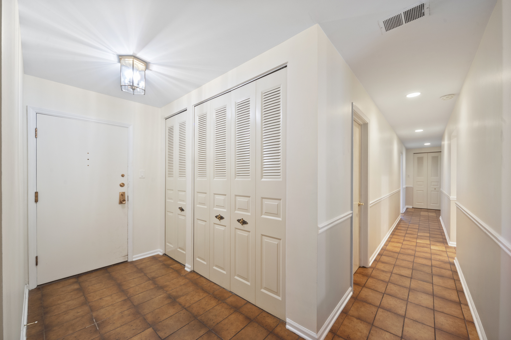 4949 Golf Road, Unit 101 Skokie, IL 60077 - Photo 3 of 22 a view of a hallway with a chandelier
