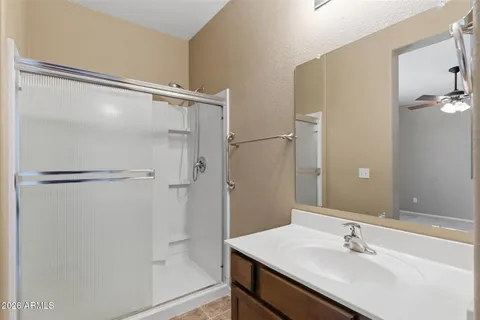 a bathroom with a shower sink and mirror