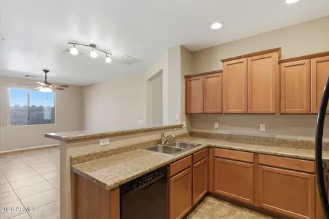 a kitchen with granite countertop a sink and cabinets